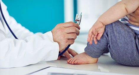 Doctor showing stethoscope to a child